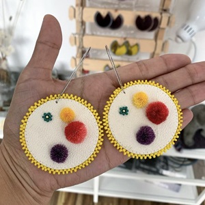 Scraped sealskin with caribou tufting beaded earrings (2021)