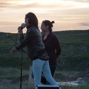 Evie Mark and Akinisie Sivuraapik performing on the beach, 2014