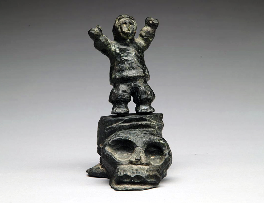 AalukLucasStandingFigureAtopASkull