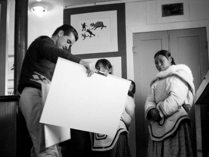Terry Ryan, Sheouak Petaulassie with a child, and a woman at West Baffin Co-operative, Kinngait, Nunavut.